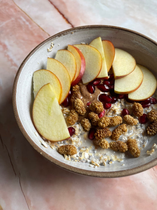 Sprouted Oat Porridge with Chia, Coconut Milk, Mulberries, Raw Almond Butter and Pomegranate.