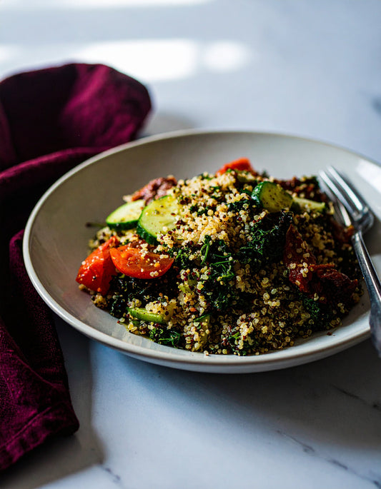 Quinoa, Kale, and Sun-Dried Tomato Salad with Cucumber, Hemp Oil, and Pomegranate Vinegar Dressing