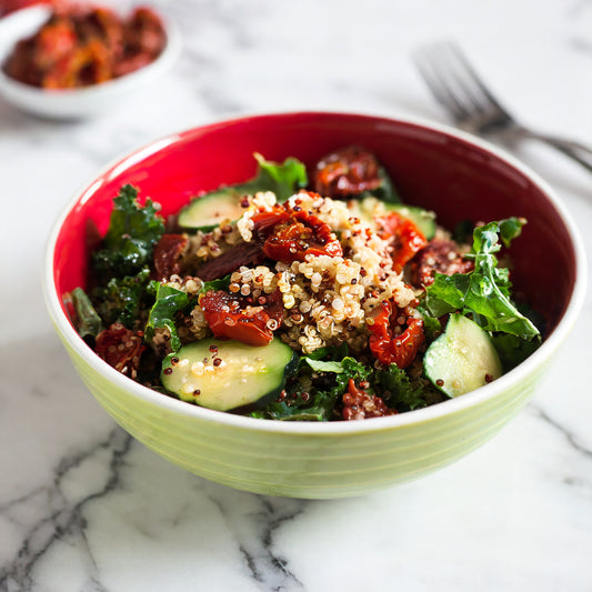 Quinoa, Kale, and Sun-Dried Tomato Salad with Cucumber, Hemp Oil, and Pomegranate Vinegar Dressing