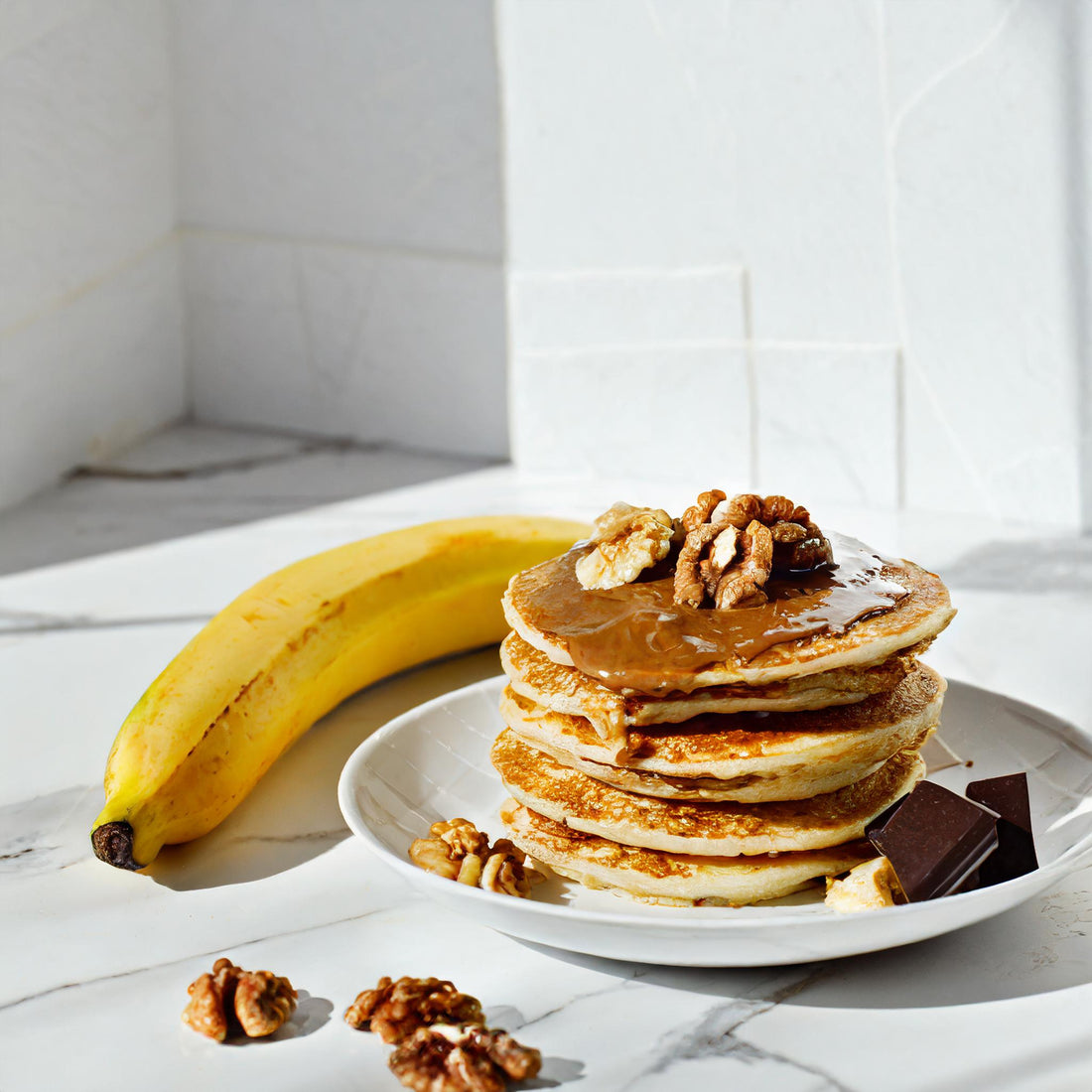 Pancakes layered with walnut butter & banana